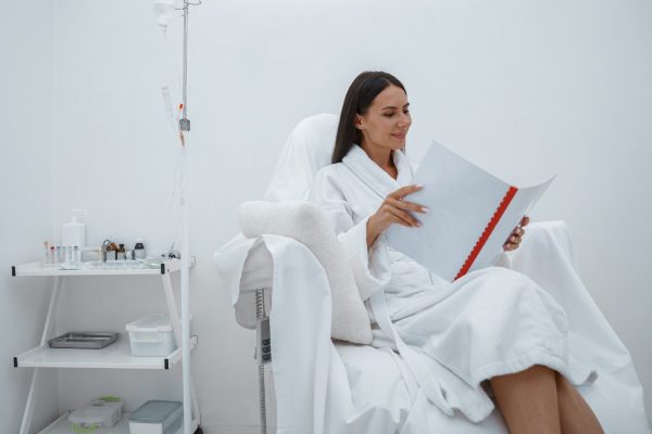 beautiful-woman-white-bathrobe-reading-magazine-while-sitting-luxury-wellness-spa-centre